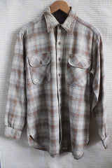 Men's vintage 1970's Pendleton label medium long sleeve button up plaid wool shirt in cream and brown colors. Two chest pockets.