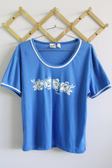 Women's vintage 1970's Liki Liki, Honolulu, Hawaii label short sleeve blue t-shirt with white Hawaii graphic on the front and white trim in polyester material.