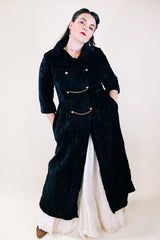 Women's vintage 1960's Raymodes, NY label long length long sleeve black velvet duster coat. Bronze buttons with bronze chains.