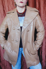 Women's vintage 1970's Nordstrom label long length long sleeve tan brown colored double breasted leather trench coat.