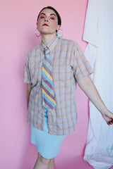 Men's or women's vintage 1970's The Fox, JCPenney label short sleeve button up shirt in yellow, grey, blue, and mauve all over plaid print. Tortoise colored buttons.