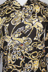 Women's vintage 1970's long sleeve button up blouse with a dagger collar in chocolate brown and tan colored all over abstract print.