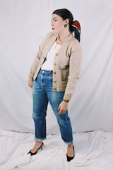 Women's vintage 1960's A Genuine Dehen, The Buddy label long sleeve light tan colored button up cardigan sweater. Ribbed texture cuffs and two front pockets.