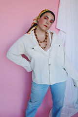 Men's or women's vintage 1970's Montgomery Ward label long sleeve cream colored cotton material button up shirt. Brown buttons and two chest pockets.