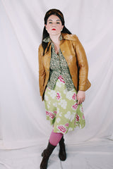 Women's vintage 1970's Made in Belgium label long sleeve light tan colored leather lightweight jacket with silver snap buttons and a dagger collar.