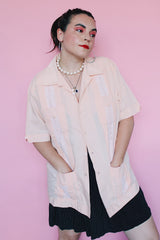 Men's vintage 1970's Mexacali label short sleeve peach orange colored button up cabana shirt with white embroidery and pleats on the front.