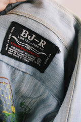 Men's or women's vintage 1970's BJ-R, Long Tail - Form Fit, Made in Hong Kong label long sleeve light blue denim chambray button up shirt with colored embroidery all over.