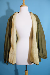 Men's or women's vintage 1950's long sleeve reversible army liner jacket. One side is a nubby cream color and one side is green Nylon.