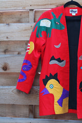 Women's vintage 1980's Mr. Girasol, Made in Mexico label long sleeve open front lightweight jacket in red with all over multicolored animals.
