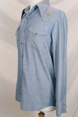 Men's vintage 1970's long sleeve chambray denim shirt with colored embroidery in the front and back.