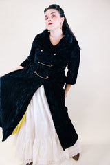 Women's vintage 1960's Raymodes, NY label long length long sleeve black velvet duster coat. Bronze buttons with bronze chains.