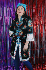 Women's vintage 1970's Bai Hua, Made in China label 3/4 arm length mid length lightweight robe jacket in black, white, blue, and an all over floral embroidered print.