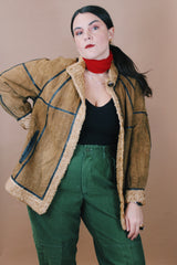 Women's vintage 1970's size medium long sleeve tan brown suede jacket with one button closure, cream fur trim, and black trim throughout.