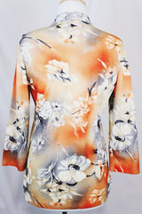 Women's vintage 1970's Pykettes label long sleeve floral printed tunic blouse with keyhole cut out front closure in grey, orange, and cream colors.