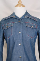 Women's vintage 1970's By Bogat of Texas long sleeve button up medium wash denim chambray top with red and white contrast stitching.