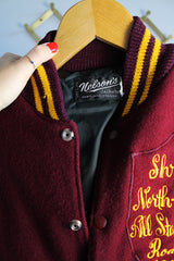 Women's or men's vintage 1982 Nelson's Jackets, Portland, Oregon label long sleeve letterman jacket with a maroon wool body and cream colored leather arms. Yellow stripped trim and popper buttons. Embroidery on chest.