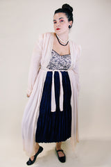 Women's vintage long sleeve long length pale pink sheer robe with an open tie front and lace trim. Has small shoulder pads and ties on cuffs.