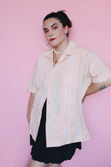 Men's vintage 1970's Mexacali label short sleeve peach orange colored button up cabana shirt with white embroidery and pleats on the front.