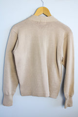 Women's vintage 1960's A Genuine Dehen, The Buddy label long sleeve light tan colored button up cardigan sweater. Ribbed texture cuffs and two front pockets.
