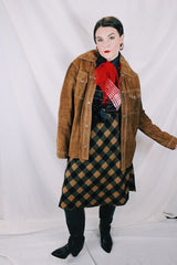 Men's or women's vintage 1970's long sleeve light brown tan colored suede jacket. Has silver snap buttons, contrast stitching, and a dagger collar.