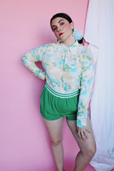 Women's vintage 1970's long sleeve button up blouse with collar in an overall yellow, green, and blue floral print. Acetate and Nylon blend material.