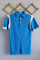 Women's or men's vintage 1960's Hilton, Made in USA label short sleeve blue and white half closure polo t-shirt with black graphic on the back.