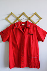 Women's vintage 1970's King Louie Creation, Made in USA label short sleeve button up bowling shirt in maroon red cotton material with embroidered trim and wording on front and back