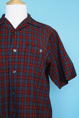 Men's vintage 1960's Pendleton short sleeve button up plaid shirt in a lightweight wool material. Red and grey colors with one chest pocket.