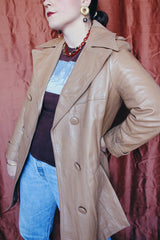 Women's vintage 1970's Nordstrom label long length long sleeve tan brown colored double breasted leather trench coat.