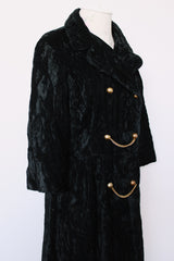 Women's vintage 1960's Raymodes, NY label long length long sleeve black velvet duster coat. Bronze buttons with bronze chains.