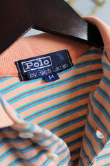 Men's or women's vintage 1990's Polo By Ralph Lauren label short sleeve peach and blue colored stripe polo tee with collar and half button closure.