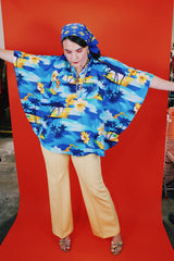 Women's vintage 1980's Made in Hawaii short sleeve wide cape blouse in all over blue Hawaiian print.