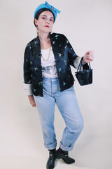 Women's vintage 1960's satin reversible robe jacket in black and grey with all over embroidered print. Mandarin collar and fabric buttons.