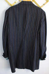 Men's or women's vintage 1970's University Seal Authentic Fashion label long sleeve navy blue wool blazer with all over pin stripes. Has pockets, textured buttons, and a back slit.