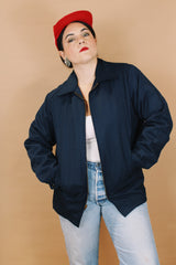 Men's or women's vintage 1970's Unitog Company, Union Made in USA label size large long sleeve navy blue station jacket that zips up the front with red nylon liner.