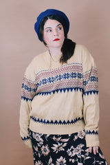 Women's or men's vintage 1980's size large long sleeve tan colored pullover sweater in an acrylic material. Navy and maroon print.