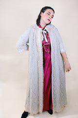 Women's vintage 1970's I. Magnin, Odette Barsa label long length short sleeve baby blue cream lace duster robe jacket with ribbon trim and peter pan collar.