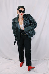 Men's vintage 1980's black genuine leather zip up motorcycle style jacket. All over silver hardware, popper buttons, and and zippers.