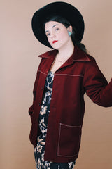 Women's or men'd vintage 1970's size medium long sleeve maroon color button up lightweight western style jacket with pockets and contrast stitching.