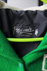Women's vintage 1989 Nelson's Jacket, Portland, Oregon label bright green wool varsity letterman jacket with white trim. Has snap buttons, patches, pockets, and a hood. Shop more vintage outerwear and sportswear at Live Forever Vintage.