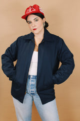 Men's or women's vintage 1970's Unitog Company, Union Made in USA label size large long sleeve navy blue station jacket that zips up the front with red nylon liner.