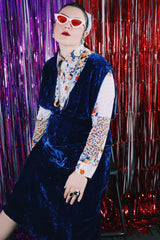 Women's vintage 1970's sleeveless dark blue crushed velvet knee length dress. Has a deep V shaped neckline in the front.