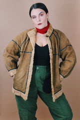 Women's vintage 1970's size medium long sleeve tan brown suede jacket with one button closure, cream fur trim, and black trim throughout.