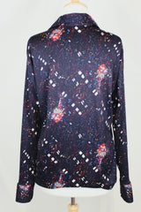 Men's vintage 1970's Maxi & Me California label long sleeve black slinky polyester material button up shirt with all over multi colored paint splatter print.