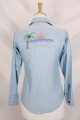 Men's or women's vintage 1970's JCPenney label long sleeve light blue chambray denim shirt with all over colored embroidery.