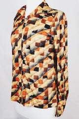 Women's vintage 1970's long sleeve button up shirt with dagger collar and all over brown and orange abstract print.