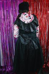 Women's vintage 1980's sleeveless off the shoulder ankle length black colored prom dress. Has a ruffled collar with all over silver metallic polka dots.