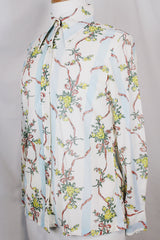 Women's vintage 1970's Knit Editions by Ship 'n Shore long sleeve button up blouse with a dagger collar in an all over white and blue stripes pattern and floral print.