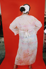 Women's vintage 1980's Valerie Stevens label long sleeve cream sheer lingerie robe with pink floral print, ruffle sleeves, and a tree button closure.