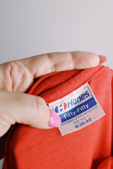 Men's or women's vintage 1980's Hanes, Fifty-Fifty, Made in USA label short sleeve red navy graphic tee in a cotton and polyester material.